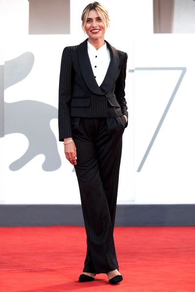 Image may contain Suit Coat Clothing Overcoat Apparel Human Person Female Tuxedo and Woman