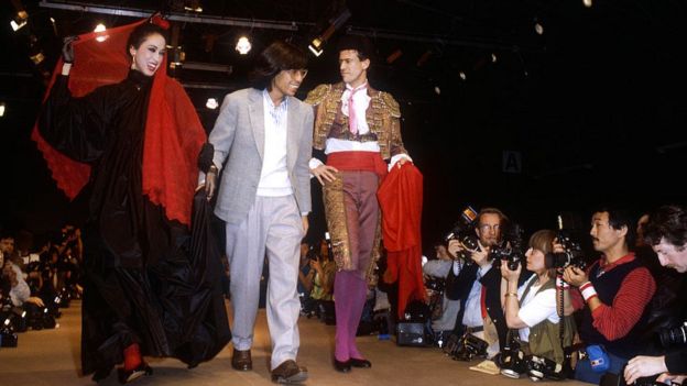 A haute couture dress and a matador's bullfighting uniform by Japanese fashion designer Kenzo Takada during his autumn-winter 1983-1984 fashion show in Paris