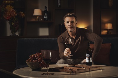 a person sitting at a table with a glass of wine