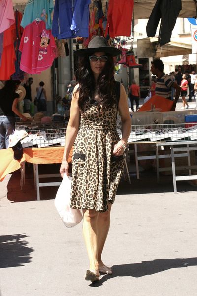A person wearing a dress and hat Description automatically generated with medium confidence