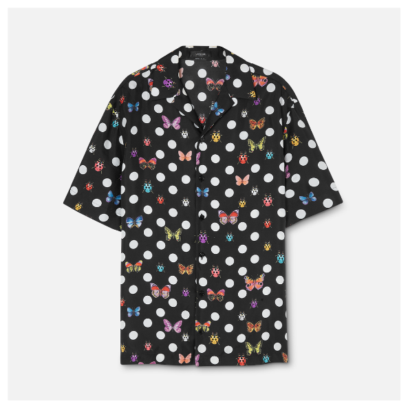 A black shirt with butterflies and polka dots Description automatically generated