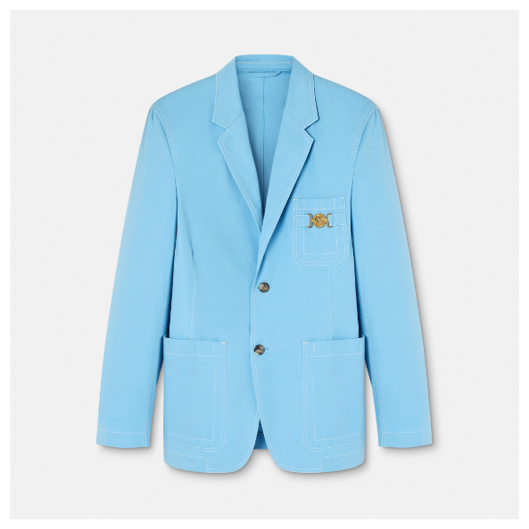 A blue blazer with a gold emblem Description automatically generated