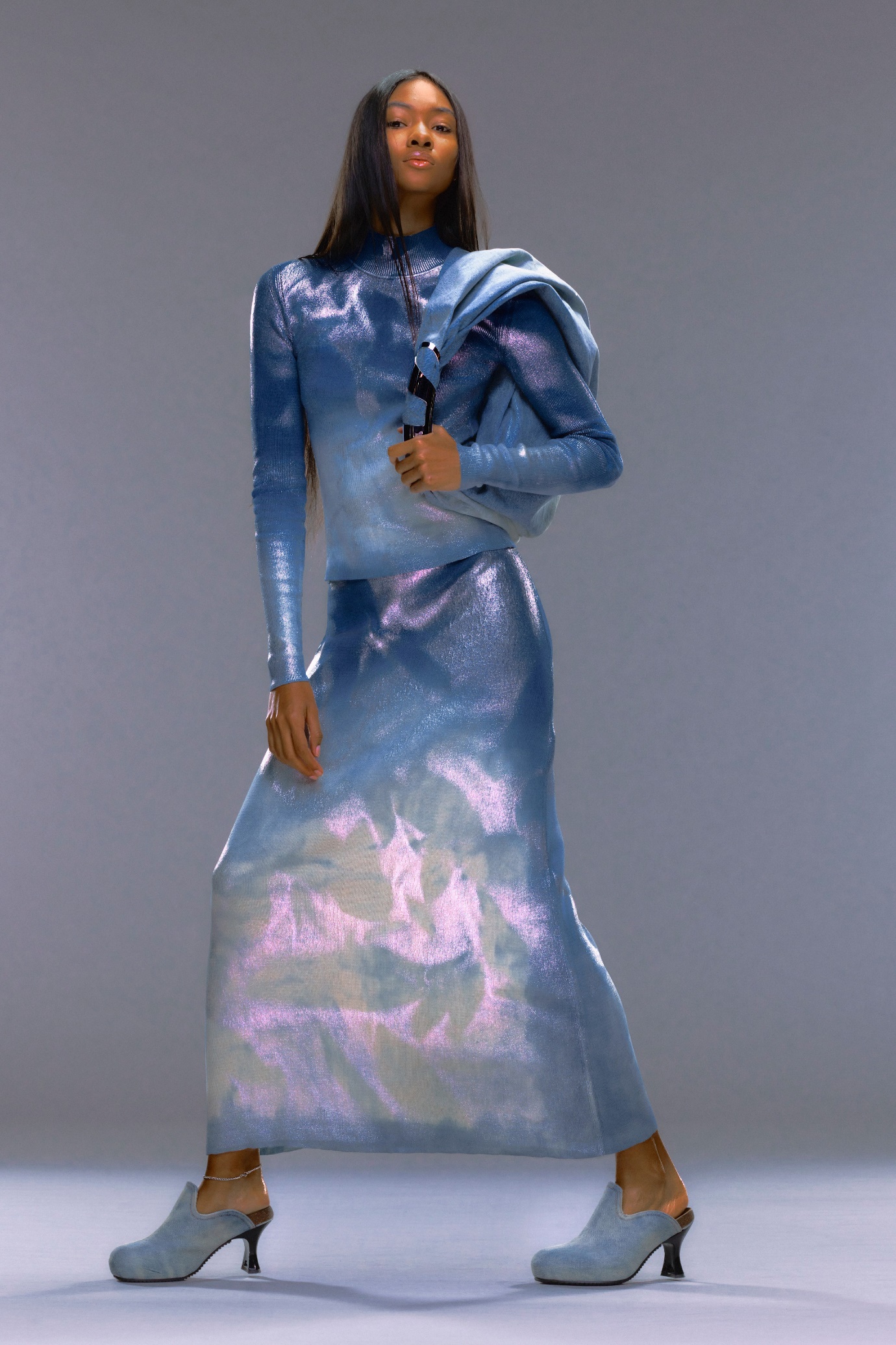 A person in a blue dress Description automatically generated