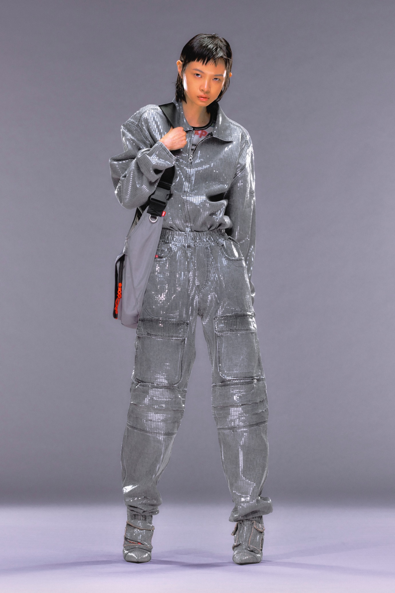 A person wearing a silver suit Description automatically generated