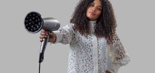 a person holding a hair dryer description automat