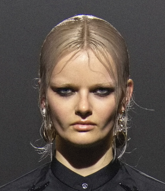 A person with blonde hair and earringsDescription automatically generated