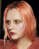 A person with orange hair Description automatically generated