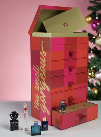 A box with a lid open and a small bottle of perfume next to it Description automatically generated