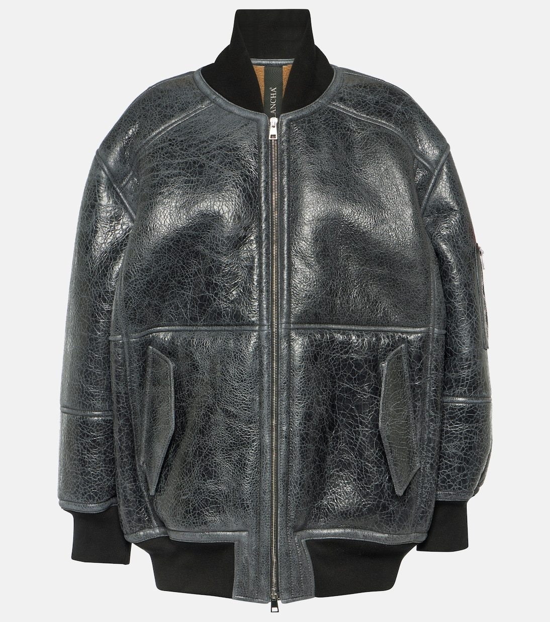 A black leather jacket on a mannequin Description automatically generated