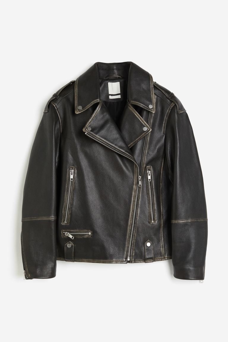 A black leather jacket with zippers Description automatically generated