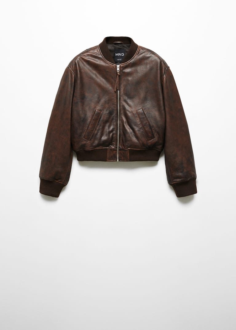 A brown leather jacket on a white wall Description automatically generated