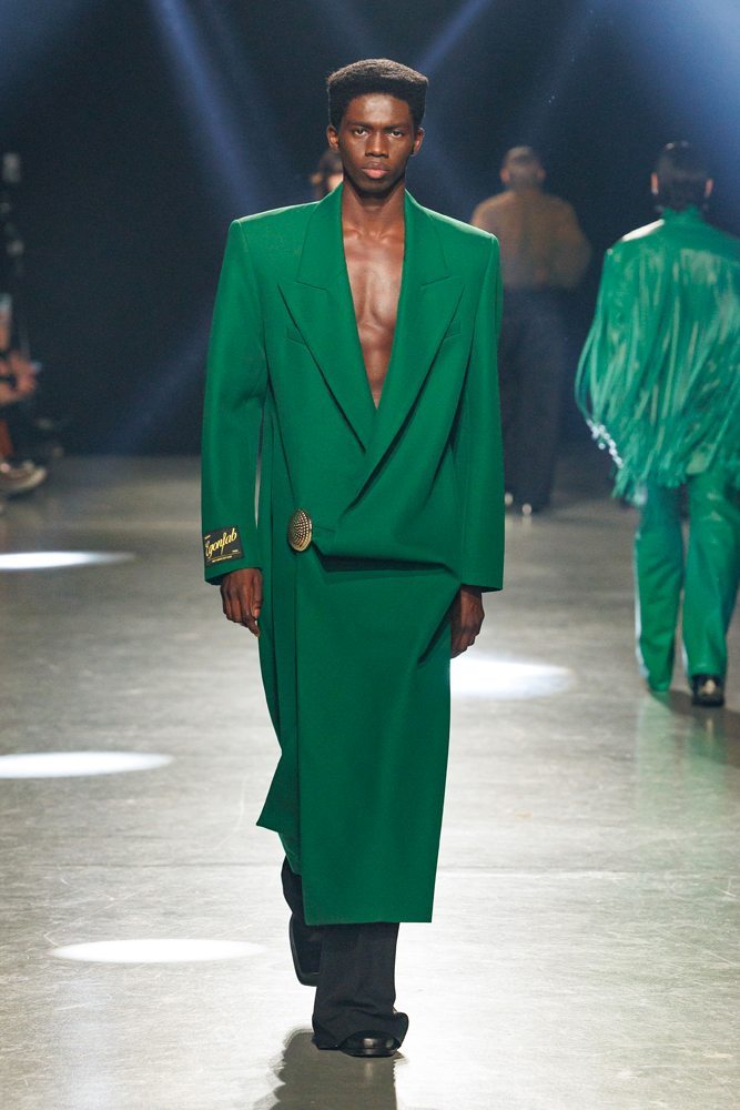 A person in a green suit Description automatically generated