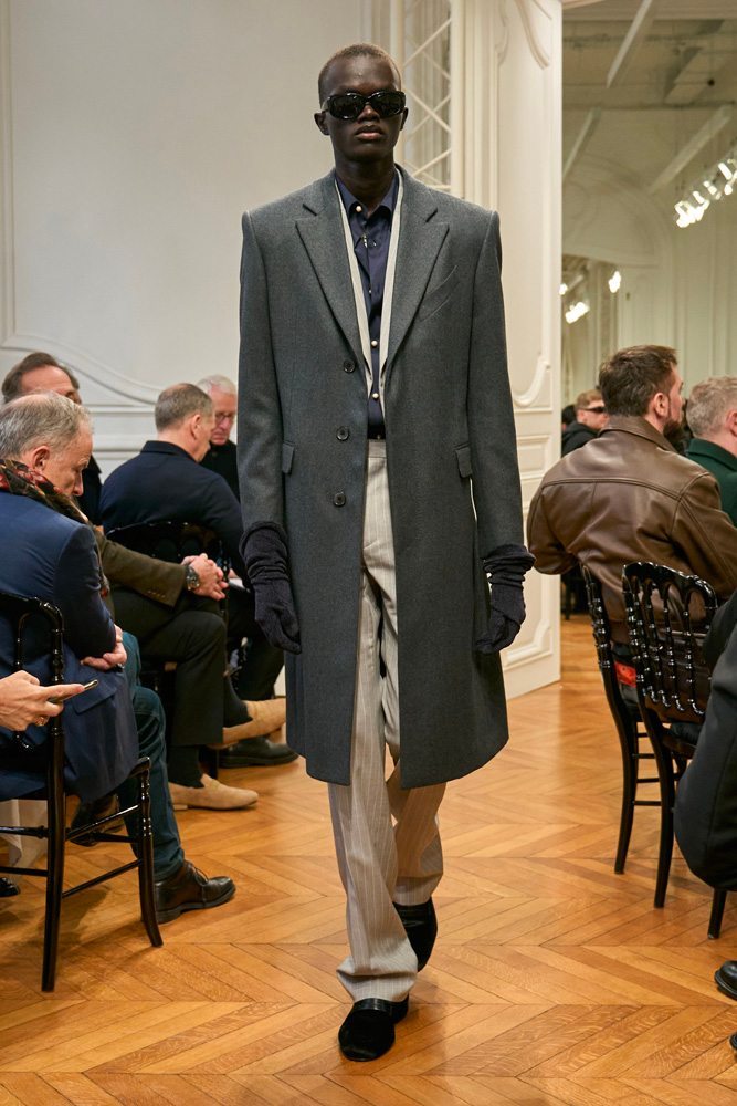 A person in a long coat Description automatically generated