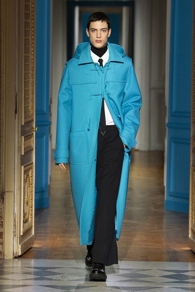 A person wearing a blue coat Description automatically generated