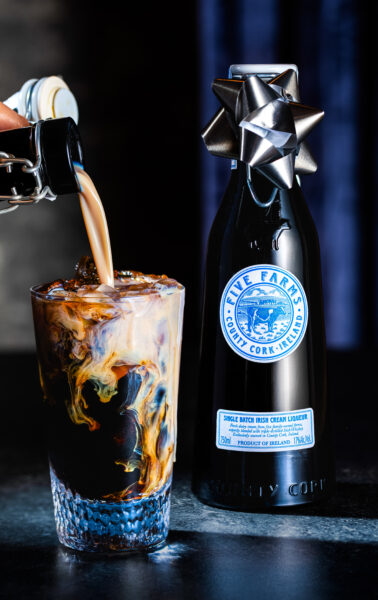 A bottle of liquid being poured into a glass, Irish Cream Liquer Latte