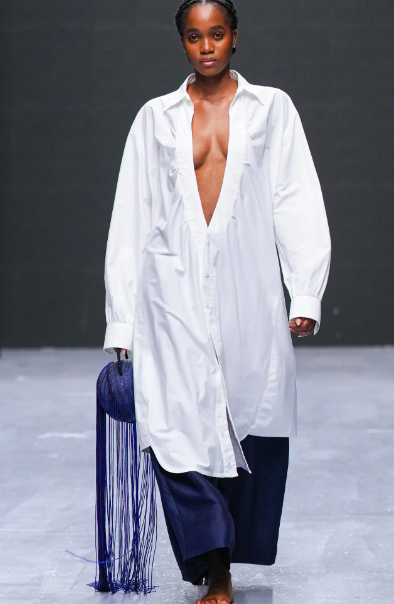 A classic oversized white tunic-shirt worn over ink-blue jeans. At Lagos Space Programme