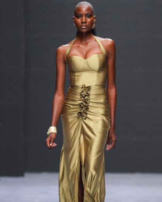 Burnt bronze in a body-hugging column dress. At Jewel Jemila